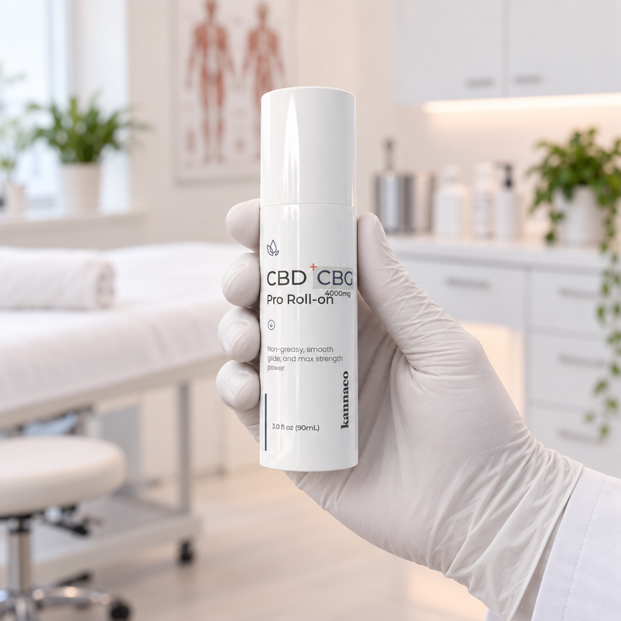 A gloved hand holding a Kannaco Pro Roll-On in a treatment room