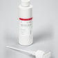 Kannaco Control & Grip Oil Jojoba + Arnica Formula 8 oz backbar bottle with cap on, next to the pump